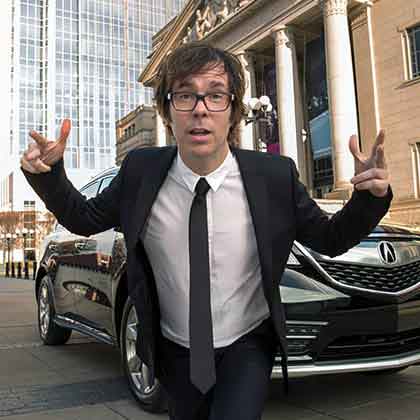 ben folds hamming it up to the camera in front of vehicle